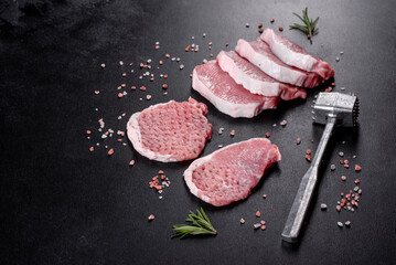 A fresh raw piece of pork escalop cut into several parts