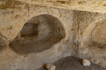 Stunning Roman catacombs carved on the sandstone cliffs above the Matala Beach, Crete, Greece. In...