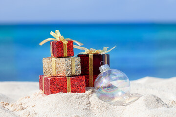 Christmas presents and ornament on the beach.