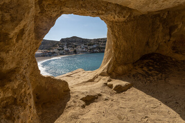 Stunning Roman catacombs carved on the sandstone cliffs above the Matala Beach, Crete, Greece. In...