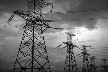  high-voltage  power lines at storm clouds.