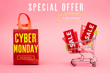 red tags with sale in shopping trolley near paper bag with cyber monday lettering on pink, stock image