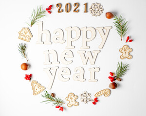  Christmas round frame, decorative border. Winter composition of numbers 2021, fir branches, red berries on a white background.Flat lay and copy space