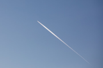 airplane contrail against clear blue sky