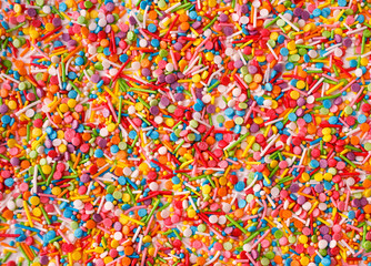 Close up of colorful eatable sugar sprinkles for food decoration. Candy texture.