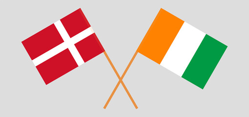 Crossed flags of Denmark and Republic of Ivory Coast