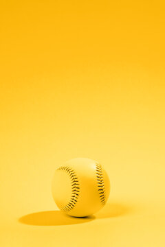 Baseball ball on yellow background. Team sport concept