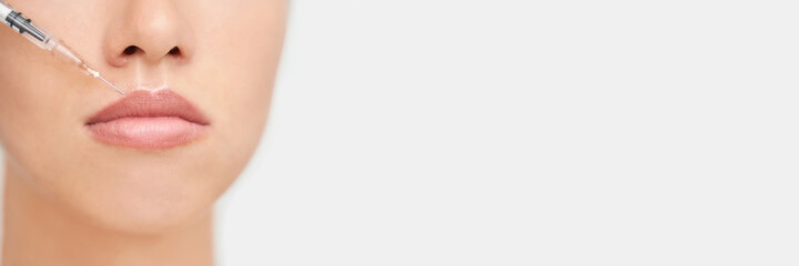 Obraz premium Near eye injection at spa salon. Doctor hands. Closeup. High quality. Pretty female patient. Beauty treatment. Healthy skin procedure. Young woman face. Crows feet wrinkle. Plasmolifting rejuvenation