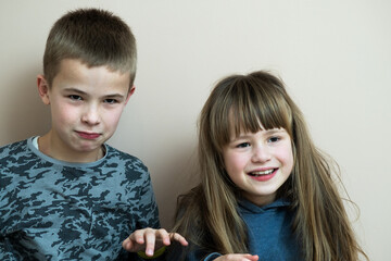 Two children boy and girl fooling around having fun together. Happy childhood concept.