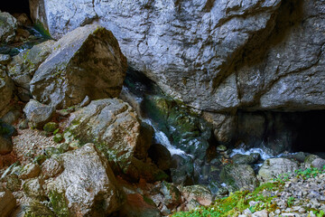 Naklejka na ściany i meble Cave river and waterfall