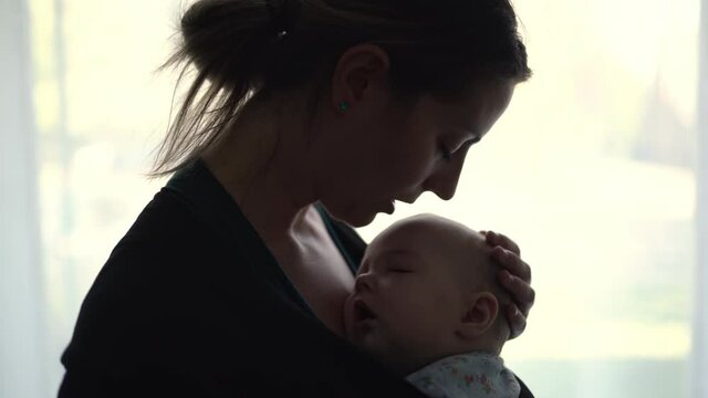young mother with her daughter in sling Baby Carrier