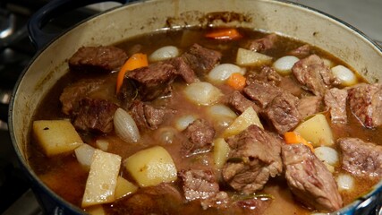 Homemade beef and vegetable stew cooking on the stove