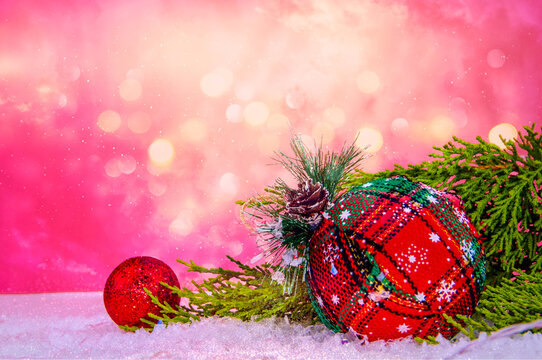 close-up red christmas decorations, snow and pine tree