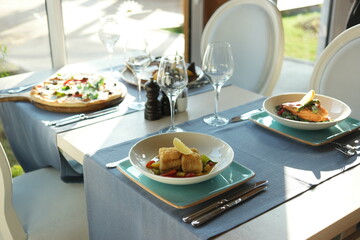 Lunch in the restaurant. Delicious dishes on beautifully served table.