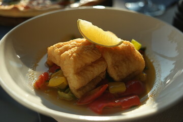 Fried fish fillets and vegetables. Delicious fish dish in plate. Food concept.