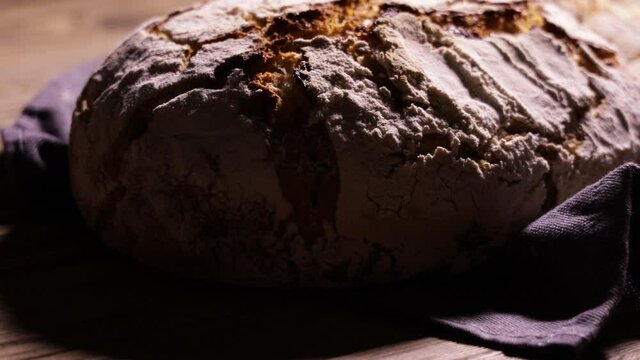 freshly baked homemade "country-style" rye bread on an old wooden table