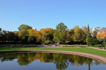 Fototapeta na wymiar Beautiful warm autumn day at Mokotow Field (Polish: Pole Mokotowskie) - a large park complex with artificial pond. Warsaw, Poland, Europe