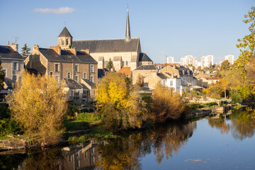 View on the clain river in Poitiers. There is a church. Sunny day, photographed in the autum.