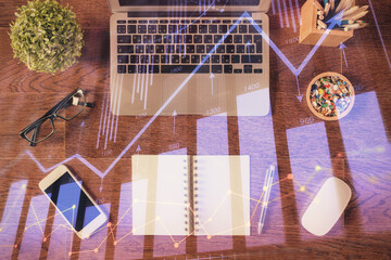 Stock market graph and top view computer on the table background. Multi exposure. Concept of financial education.