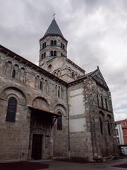 Fototapeta na wymiar The Basilica of Notre-Dame du Port is a Romanesque basilica, formerly a collegiate church, in the Port quarter of Clermont-Ferrand in France, between Place Delille and the cathedral.