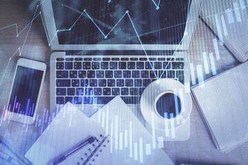 Stock market chart and top view computer on the table background. Double exposure. Concept of financial analysis.