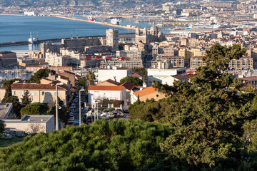 Fototapeta na wymiar View of the city of Marseille from the hill where Notre-Dame de la Garde is located. View on the coast and the Mediterranean sea. 