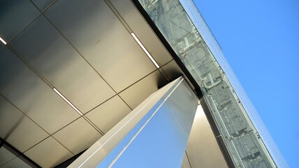 Combination of metal and glass wall material. Steel facade on columns. Abstract modern architecture. High-tech minimalist office building. Contemporary business architecture abstract fragment.