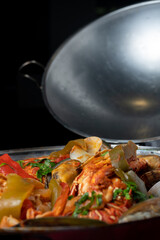 Seafood cataplana, typical Portuguese dish, with lobster, shrimps, mussels, vegetables.