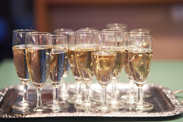 Glasses of champagne on a silver tray at a family celebration