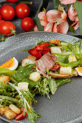 caesar salad on a gray plate with decor and copyspace