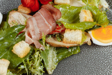 caesar salad on a gray plate with decor and copyspace
