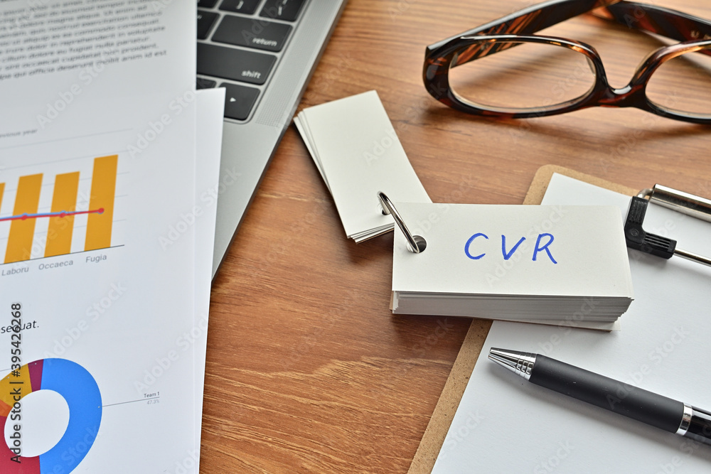 Poster on top of the notebook and clipboard is a wordbook and pen with the word cvr written on it. it means