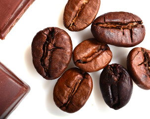 pieces of chocolate and roasted coffee beans isolated on white. flat lay