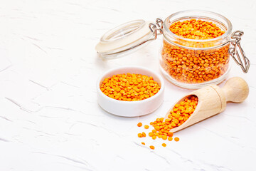 Dry orange lentils in glass jar