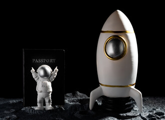 astronaut cheering up with a passport on back on a planet with craters
