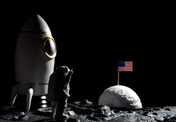 astronaut cheering up and facing the American flag on a planet with craters at horizontal...