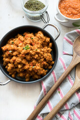 Closeup view of a casserole full of delicious bolognese soya meat .