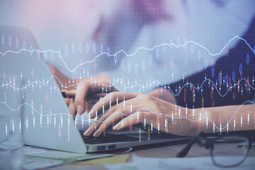 Multi exposure of woman hands typing on computer and financial graph hologram drawing. Stock market analysis concept.