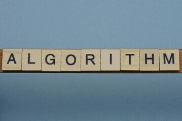 text the word algorithm from brown wooden small letters with black font on an gray table