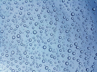 Water drops in blue with shallow depth of field