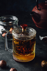 Steeping red tea in glass mug with cap