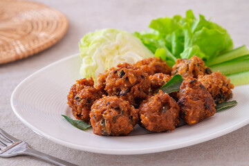 Deep fried spicy minced pork served with vegetable on  plate, Thai food