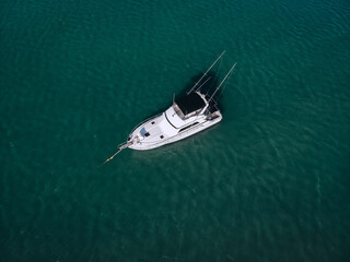 Fototapeta premium aerial View Of little yacht with black sail At The Andaman sea. Phuket. Thailand
