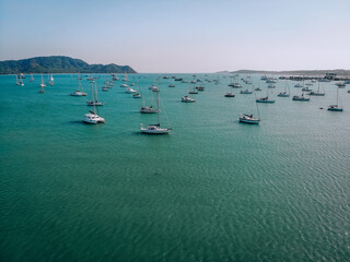 Fototapeta na wymiar Aerial view of many anchoring yacht in open water. Ocean and sea travel and transportation. Phuket. Thailand.