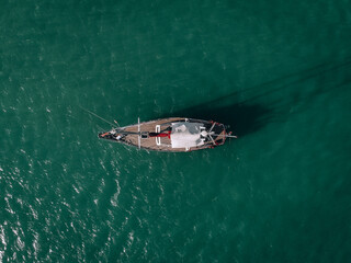 Aerial view of a  sailing yacht in the turquoise water of the Andaman sea. Phuket. Thailand