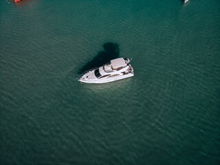 Fototapeta premium Aerial photo of an isolated luxury white yacht design in the sea