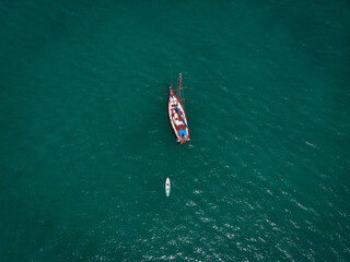 Aerial view of a  sailing yacht  with white kayak in the turquoise water of the Andaman sea. Phuket. Thailand