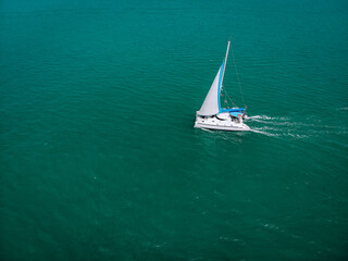 Aerial view of a  sailing yacht in the turquoise water of the Andaman sea. Phuket. Thailand