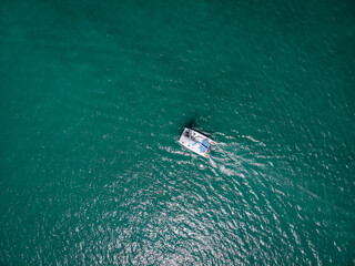Aerial view of a  sailing yacht in the turquoise water of the Andaman sea. Phuket. Thailand