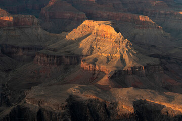 close up of setting sun shining on part of the grand canyon national park from hopi point in arizona